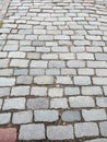 City street paved with colorful cobblestones pavement with ground between the plates