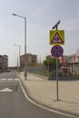 City street with a pedestrian crossing, a speed bump and a caution sign `children` near a beautiful kindergarten. Royalty Free Stock Photo