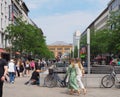 City street with pedestrians walking down the sidewalk surrounded by tall buildings in Hanover