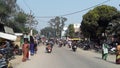 City street road with lot of people shop bike tree & sky seen