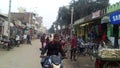 City street road with lot of people shop bike trees buildings & auto