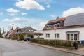 City street of single-family modern houses Germany against blue sky. German suburban small town residential area with Royalty Free Stock Photo