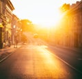 City street at sunset, bright sunlight. Blurred image, abstract urban background and texture