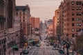 A city street with tall buildings at sunset - Amsterdam Avenue from Columbia University, in Morningside Heights, New York City