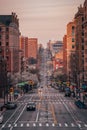 A city street with tall buildings at sunset - Amsterdam Avenue from Columbia University, in Morningside Heights, New York City