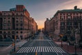 A city street with tall buildings at sunset - Amsterdam Avenue from Columbia University, in Morningside Heights, New York City