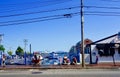 City street in tourist town with unusual wavy fence and people walking