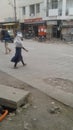 City street - an unknowing girl with white scarf crossing the road, Solapur