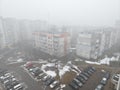 city streets are covered with fog with protruding gray houses