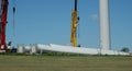 2 cranes with 2 rotor blades for a wind turbine are ready for installation, 2010