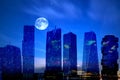 City on sunset  modern buildings silhouette of the blue  night  and moon light and houses at  pink  sunset blue cloudy night sky t Royalty Free Stock Photo