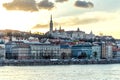 City at sunset with warm clouds reflecting on water Royalty Free Stock Photo