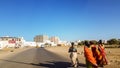 Arab women who wear veils and are traveling by foot.