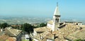 City top view. High tower on a background of hills. Sunny day