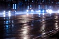 Cars driving on wet road after rain at night Royalty Free Stock Photo