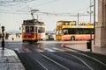 City tram and yellow tourist bus on the seafront