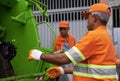 City, trash and people with garbage truck working in waste management and maintenance service. Urban, cleaning and men Royalty Free Stock Photo