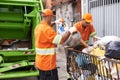 City, trash and people with garbage truck working in waste management and maintenance service. Urban, cleaning and men Royalty Free Stock Photo