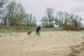 City Tuja, Latvia. A woman collects garbage on the beach Royalty Free Stock Photo