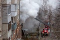 City Tula. Russia - December 01, 2020: Smoke during a fire in a multi-storey building. A fire truck and firemen arrived to