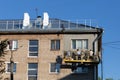 City Tula. Russia - July 24 , 2021A mans house painters paint a residential building on a front lift