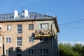 City Tula. Russia - July 24 , 2021A mans house painters paint a residential building on a front lift