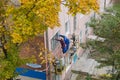 City Tula. Russia - October, 04 , 2021A mans house painters paint a residential building on a front lift