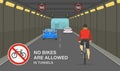 City tunnel restrictions. Cyclist ignoring road or traffic rule and riding his bike in high-speed tunnel.