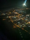 Night city under the wing of an airplane