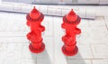 Fire hydrants red color on blueprints background. 3d illustration