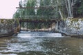 City Vaive, Latvia. River with water and locks, forest and trees Royalty Free Stock Photo