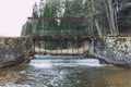 City Vaive, Latvia. River with water and locks, forest and trees Royalty Free Stock Photo