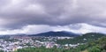 City view arial angle with storm cloud above mountain, huge dramatic rain coming from the mountain. dark cloudy day in tropical