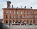 City view of a brick house on the embankment of the Fontanka river and a tram.