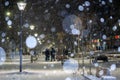 City view, lights, falling snow, night, street, bokeh spots Royalty Free Stock Photo