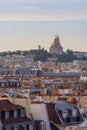 City view of Parisian rooftops and Sacre-Coeur minor basilica. Sacred Heart church in Montmartre hill. Landmark in Paris, France. Royalty Free Stock Photo