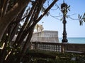 City walls with the bastion Baluarte de la Candelaria and the park of Alameda Apodaca in the Old Town of Cadiz, Spain