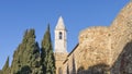 The city walls and the bell tower of the Duomo of Pienza illuminated by the morning sun, Siena, Tuscany, Italy Royalty Free Stock Photo