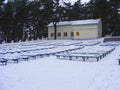 City winter park with a row of snow benches, sanatorium in winter time, benchs covered with snow