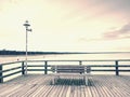 City wooden ocean pier for tourist against misyt sky. Travel destination