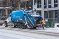 City worker emptying garbage into refuse truck