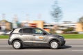 The CityBee car sharing vehicle drives quickly down the street, side view. Motion blur. Riga, Latvia - 09 Sep 2021