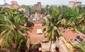 Citycape with palms, houses and tiled roofs of tropical town