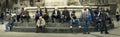 Citylife panorama. People sitting on the steps of a fountain