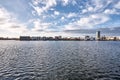 Cityscape across a lake under a blue cloudy sky on a mild winter morning