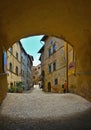 Cityscape with arch on the narrow street in old historic alley in the medieval village of Anghiari near city of Arezzo