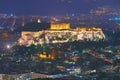 Cityscape of Athens with illuminated Acropolis hill, Pathenon and Herodium construction and sea at night. Athens skyline Royalty Free Stock Photo