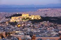 Cityscape of Athens with illuminated Acropolis hill, Pathenon and sea at night, Greece