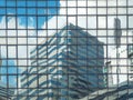 Cityscape background of blue sky with white clouds and skyscraper reflection on glass wall and windows Royalty Free Stock Photo