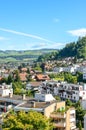 Cityscape of beautiful Alpine town Thun in Switzerland. Houses in the valley surrounded by green hills. The city is located at the Royalty Free Stock Photo